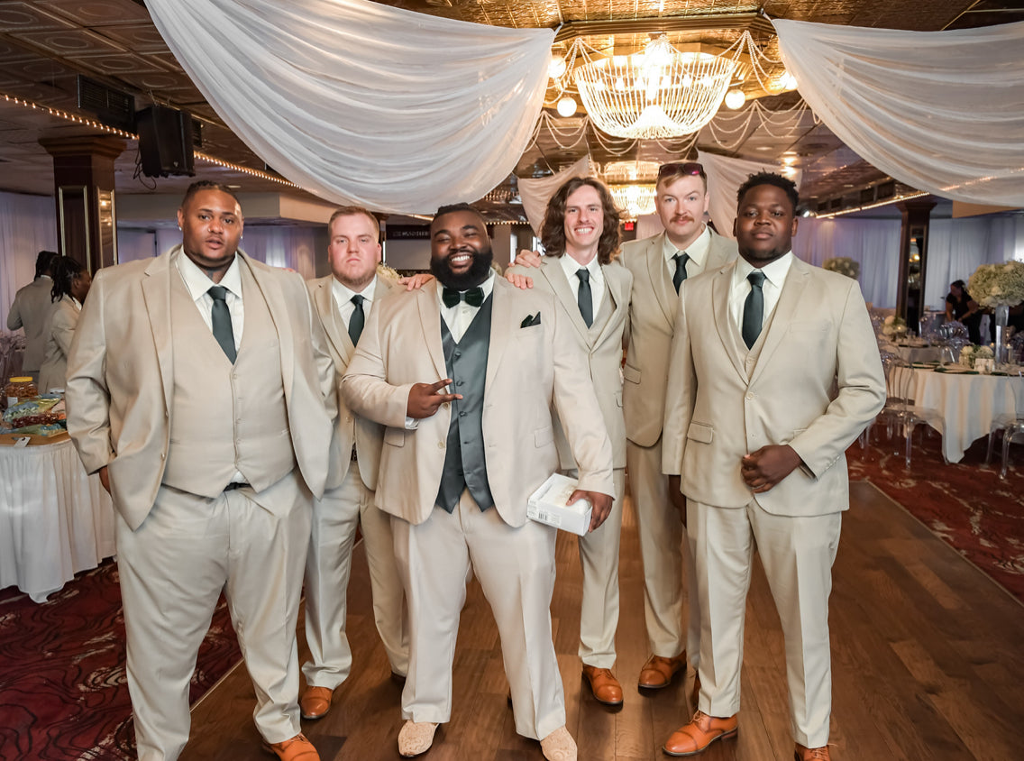 Groom and groomsmen in their beige vested suits.