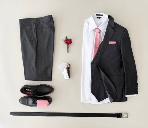 Studio shot charcoal grey vested (optional) suit, white dress shirt, champagne colored tie and pocket square, black dress shoes, with champagne socks, and black belt.