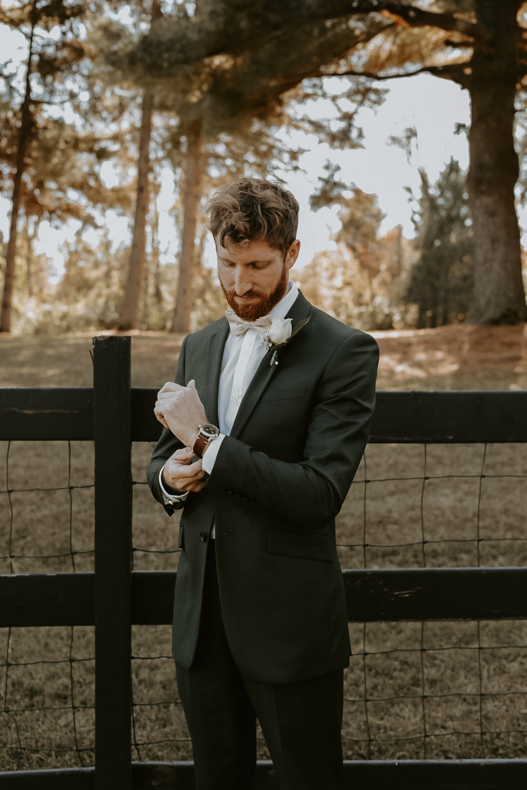 Groom wearing hunter green suit
