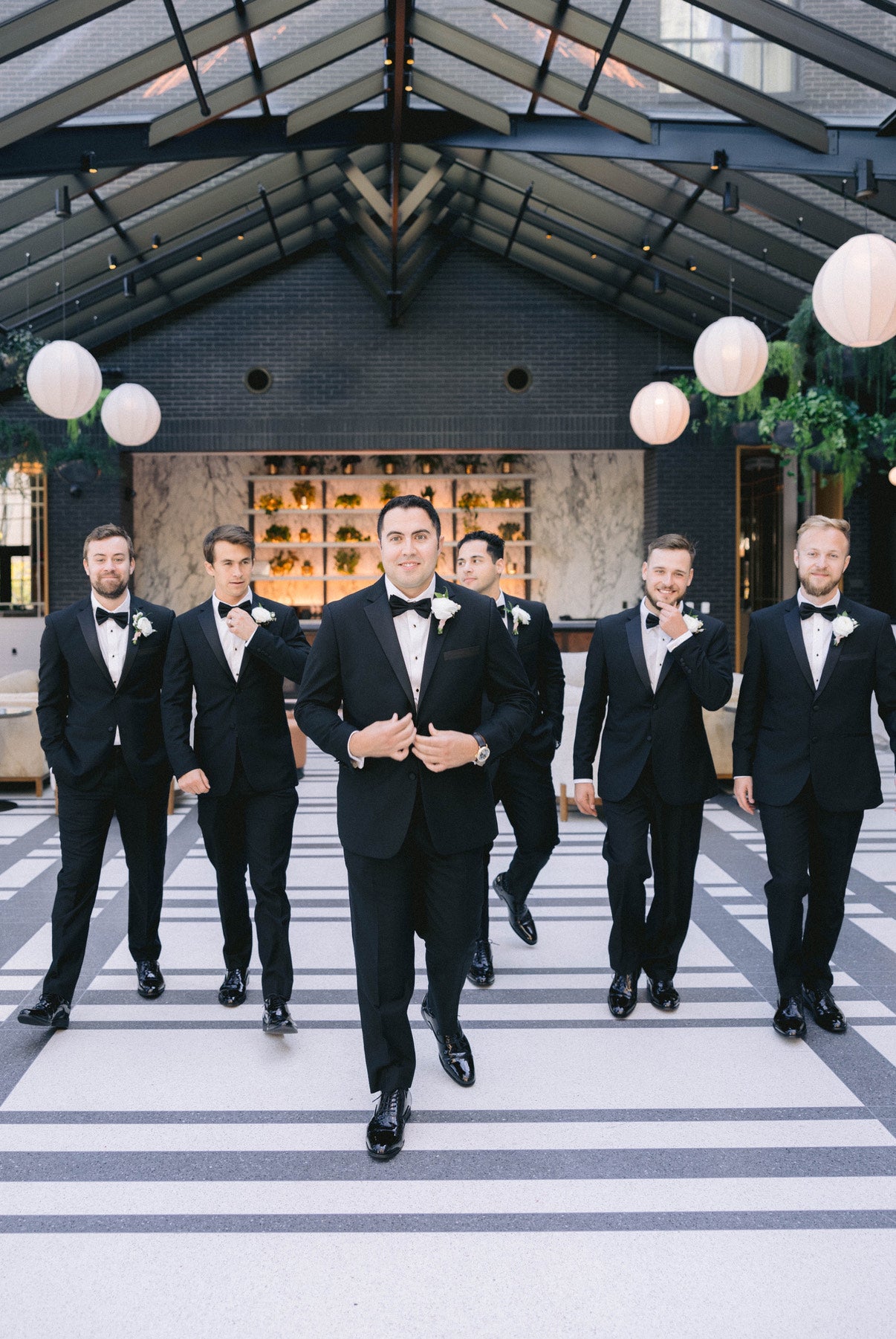 Groom and groomsmen wearing classic notch lapel tuxedos.