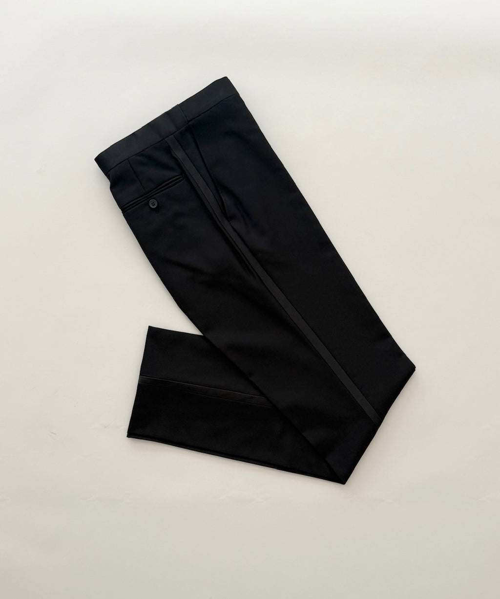 Black tuxedo pant showing a satin stripe down the leg.