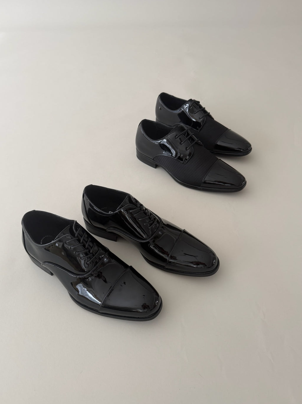 Traditional patent leather dress shoes and a fashion patent leather with woven fabric style for tuxedos.