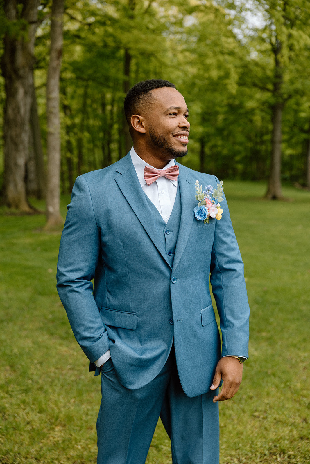 Handsome man wearing a vested powder blue suit.